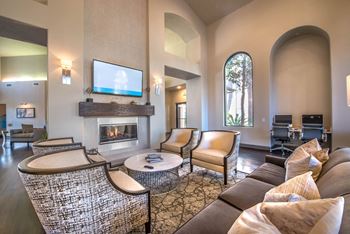 a living room with couches and chairs and a fireplace